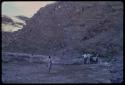 People standing by a tall rock face