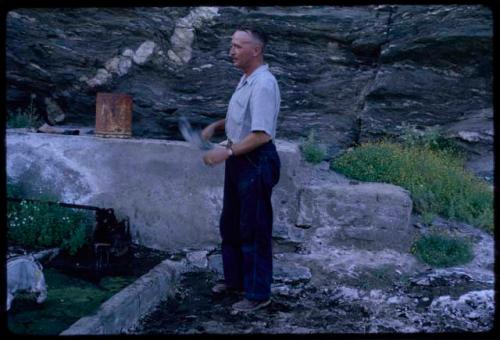 Man standing by a water reservoir