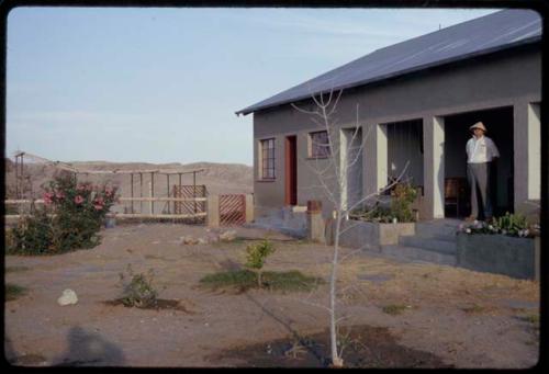 Man standing on the porch of a house