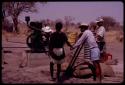 Group of people building a water pump; ǂToma and /Gao pulling on a rope