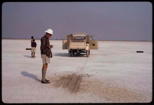 People standing, preparing for arrival on Thinthuma Pan of airplane bringing Laurence Marshall