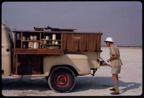 Claude McIntyre making tea on the back of a truck