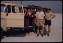 Leslie McIntyre and his friend standing beside a truck