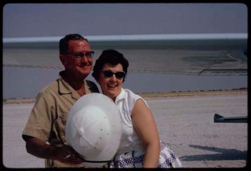 Claude McIntyre and Cynthia McIntyre standing by a plane, close-up view