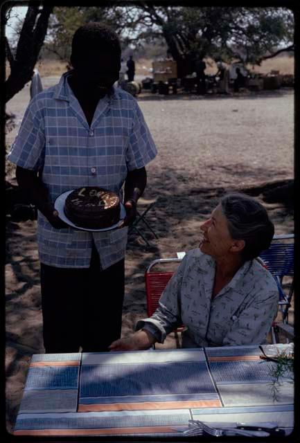 Philip Hameva presenting Lorna Marshall with a birthday cake