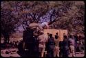 Kurt Ahrens on truck, other expedition members standing around the truck