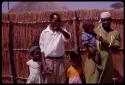 Kernel Ledimo, his wife and 3 children standing by their fence