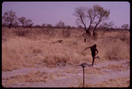 Boy running along the road which leads to ǂToma's land