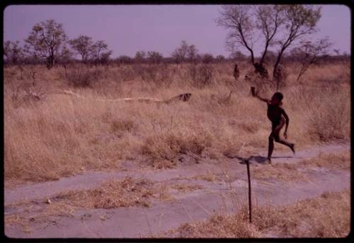 Boy running along the road which leads to ǂToma's land