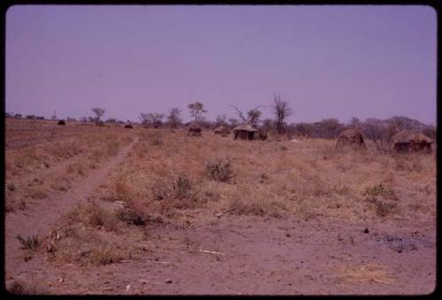 ǂToma's land, showing part of plowed area and huts in distance