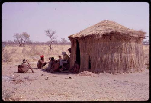 Lorna Marshall, Wilhelm Camm, "Gao Medicine", and other people sitting outside ǂToma's hut