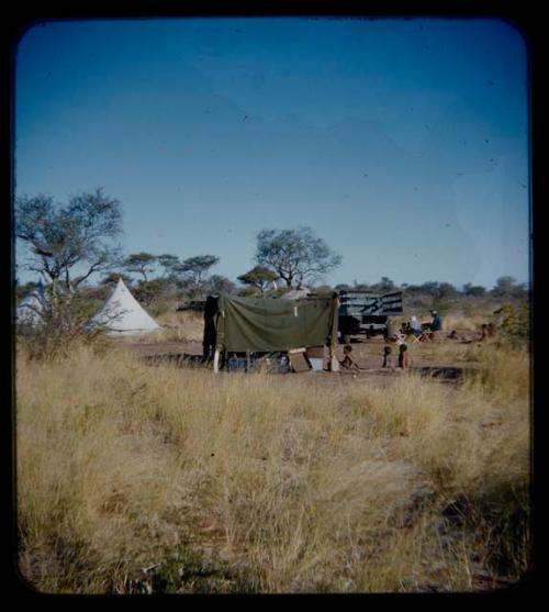 Expedition: Expedition members (including Lorna Marshall) and men having a sound recording session, seen from a distance