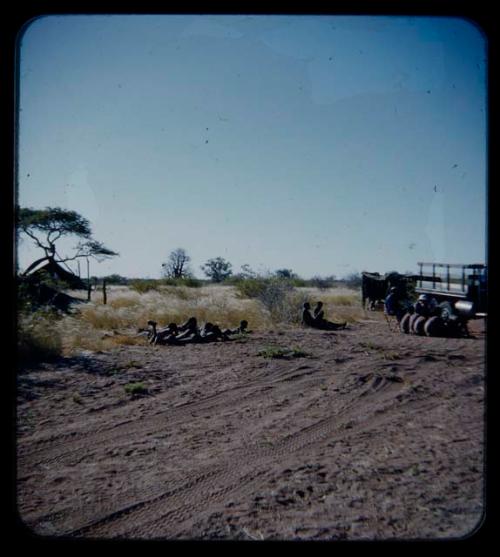 Expedition: Expedition members (including Lorna Marshall) and men having a sound recording session by a truck, seen from a distance