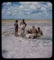 Expedition: John Marshall, Ngani, and other people gathered around a dead animal on the ground