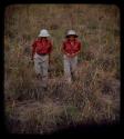 Expedition: Elizabeth Marshall Thomas and Lorna Marshall walking through grass on their trip to "Kubi"