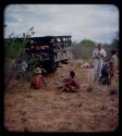 Expedition: John Marshall, Ngani, and other men gathered around a flat tire on their trip from "Kubi"