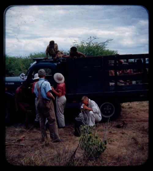 Expedition: John Marshall drinking from a cup, Elizabeth Marshall Thomas, Lorna Marshall, Ngani, and other people speaking in the background, on their trip from "Kubi"