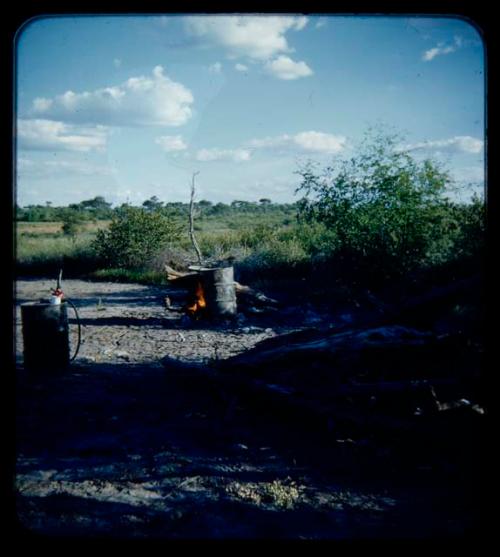 Expedition: Water boiling in two drums, distant view