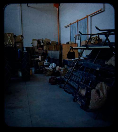 Expedition: Person looking through a box at a warehouse