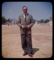 Expedition: Dr. Wagner in a suit standing in town, holding something in his hands