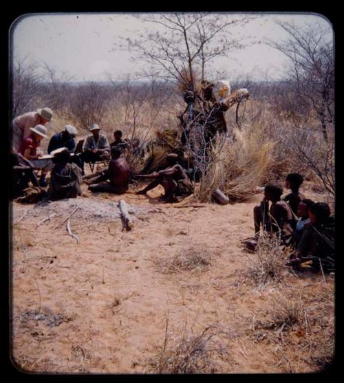 Expedition: Lorna Marshall interviewing a group of people, assisted by Kernel Ledimo, Ngani, and J. O. Brew