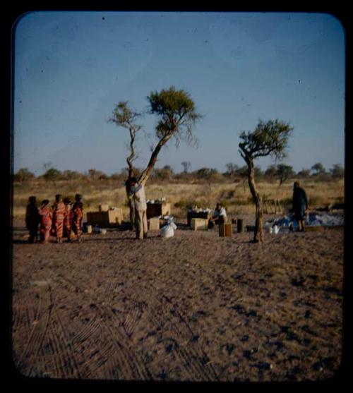 Expedition: John Marshall filming girls wrapped in gifted material, distant view