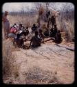 Expedition: Group of people sitting and being interviewed by Lorna Marshall, with Frederick !Gaeb interpreting, and J. Otis Brew watching