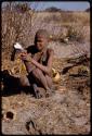 Boy placing scrotum of a gemsbok on quiver root