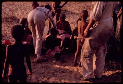 Lorna Marshall giving out gifts to a group of people after the Eland Dance