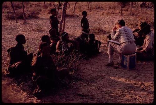 Lorna Marshall and Wilhelm Camm interviewing a group of people