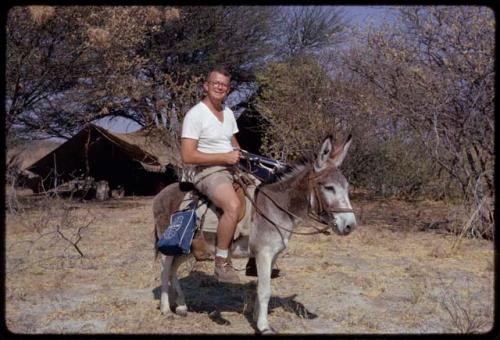 Nicholas England riding on a donkey