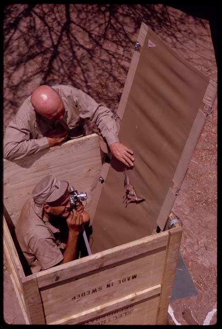 Wulf Haacke photographing a bat in a box, assisted by O.P.M. Prozesky