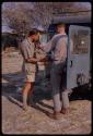 Kurt Ahrens and Nicholas England standing beside an expedition Land Rover