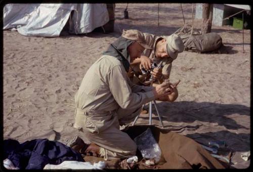 O.P.M. Prozesky and Wulf Haacke squatting and examining bats