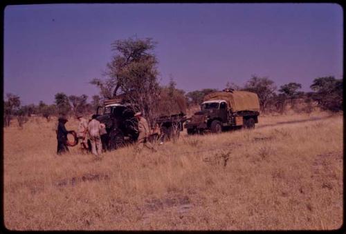 Expedition members getting ready to change an expedition truck's tire