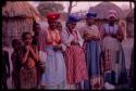 Visiting women wearing "modern" Herero dresses and children standing