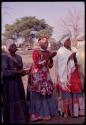 Three women wearing "modern" Herero dress and clapping