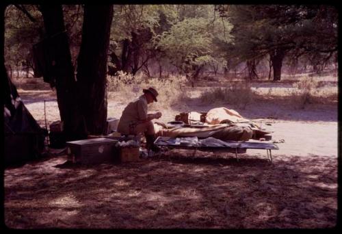 C.J. Mathias sitting on his cot at the expedition camp