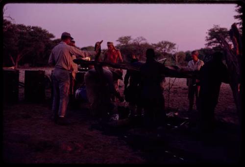 Group of people filling water barrels at Urobitsi's well