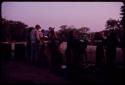 Group of people filling water barrels at Urobitsi's well