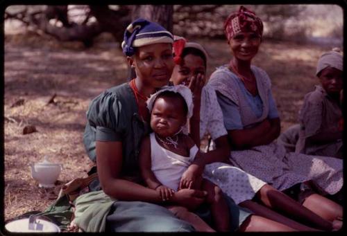 Women and children sitting at the expedition camp