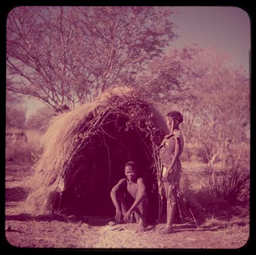 Marriage: Bau standing next to Tsamgao sitting, in front of a skerm