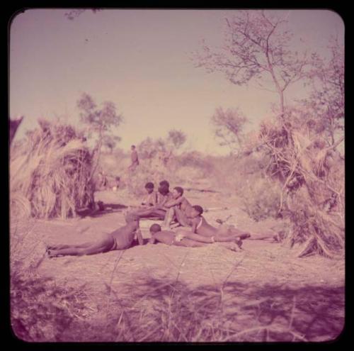 Music: "/Gao Music" playing a //guashi, sitting with a group of men including //Ao, !Naishi (his brother), Tsamgao and "Old Demi" lying down