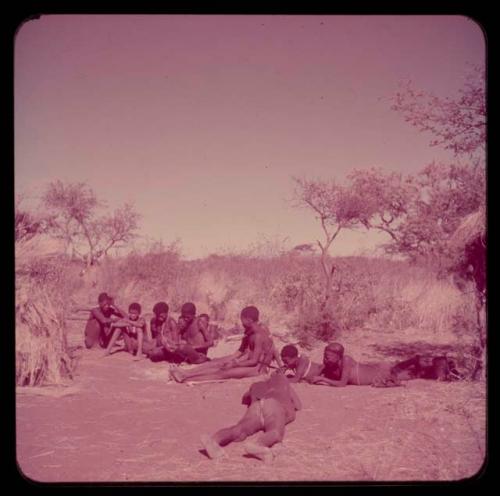 Music: "/Gao Music" playing a //guashi, sitting with a group of men including //Ao, !Naishi (his brother), Tsamgao and "Old Demi" lying down