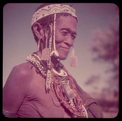 Portraits: "Old /Gam" wearing ornaments, including cowrie shells and a headdress of European beads