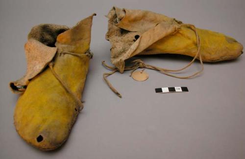 Pair of moccasins. Yellow dyed leather. Shoe style.