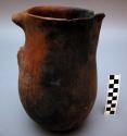 Clay pottery pitcher. Handle broken; spout chipped.