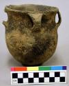 Ceramic vessel, flared rim, four handles, two broken, incised body, shell temper