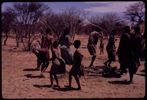 People performing the Eland Dance, with Twi imitating the sideways motion of an eland's hind legs and playing up to ǂKxoba