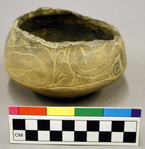 Pottery bowl with incised crude scroll design